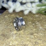 Handmade silver spinner ring with a diamond cut insert