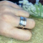 Handmade silver spinner ring with a copper insert modelled on hand