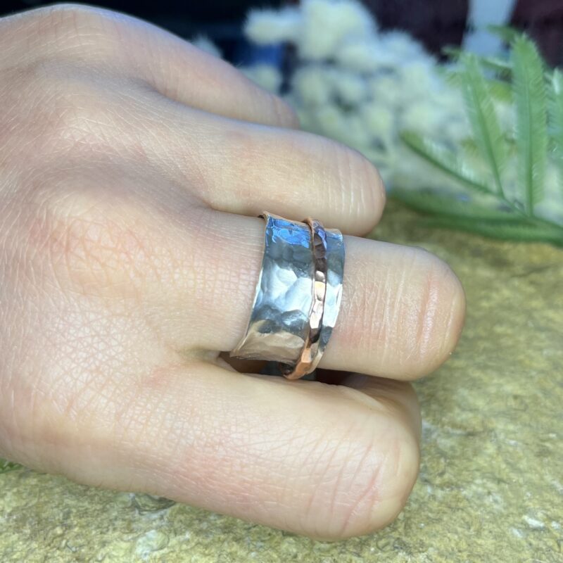 Handmade silver spinner ring with a copper insert modelled on hand Handmade silver spinner ring with a copper insert modelled on hand